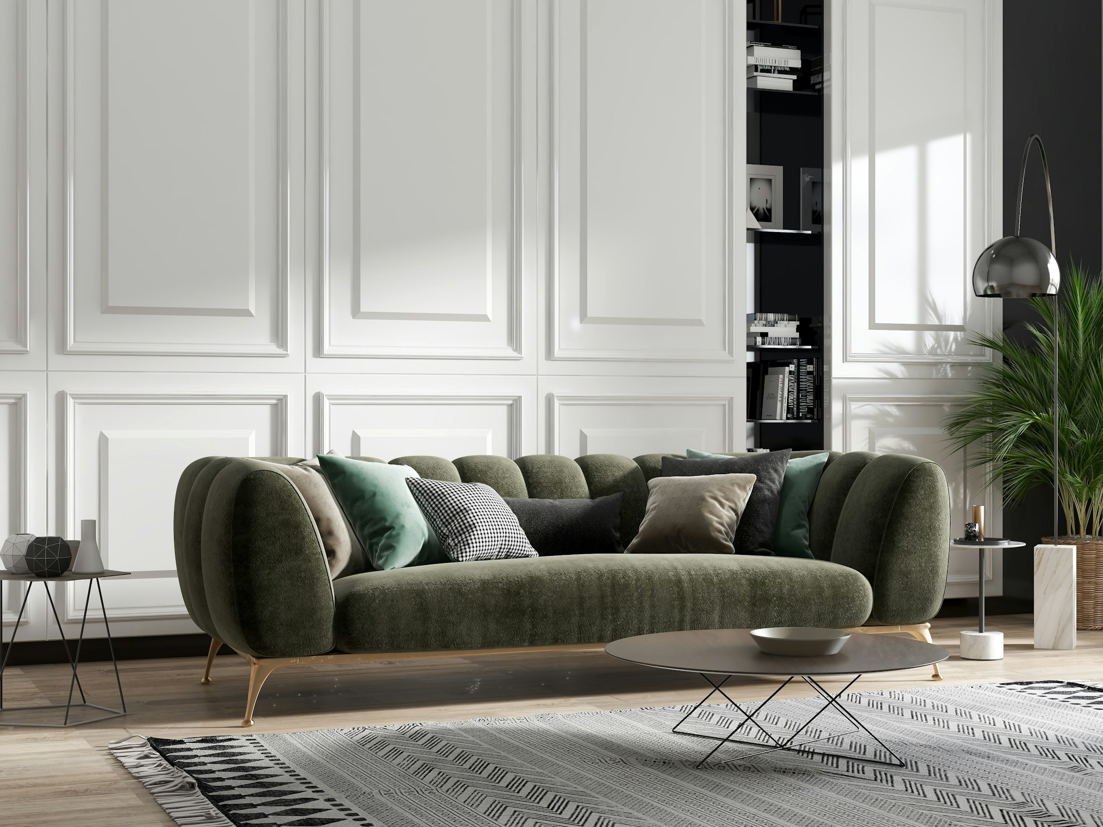 Curved olive velvet sofa in a white panelled room with a low oval coffee table
